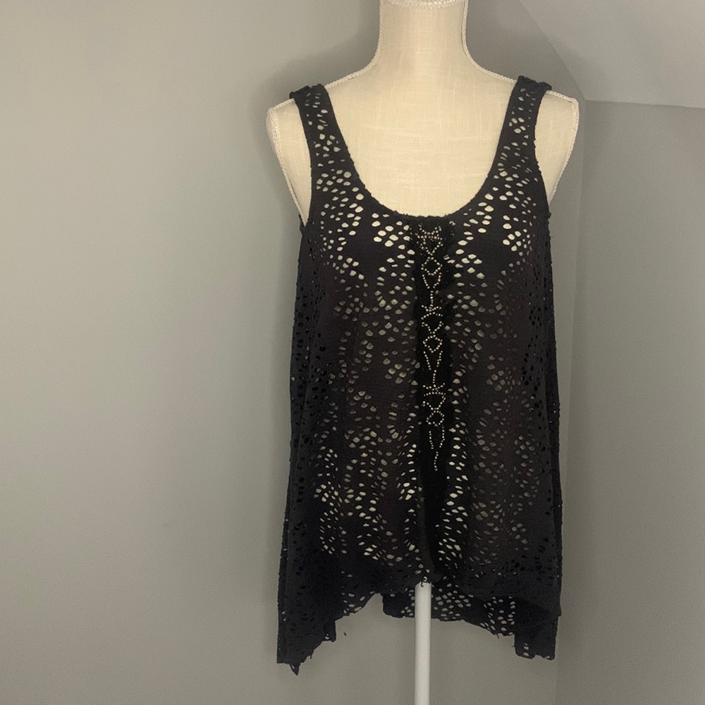 A symmetrical cut woman tee no size probably a medium, dark blue color.